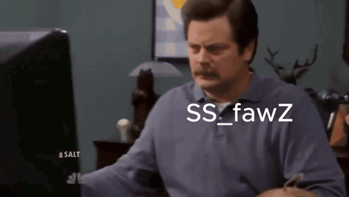 A Man With A Mustache Is Looking At A Computer Screen With The Words Ss Fawz Written On It GIF