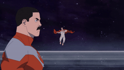 A Man With A Mustache Is Looking At A Superhero Flying Through The Air GIF