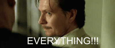 A Man With A Mustache Is Looking At Another Man With The Words Everything Written Above Him GIF