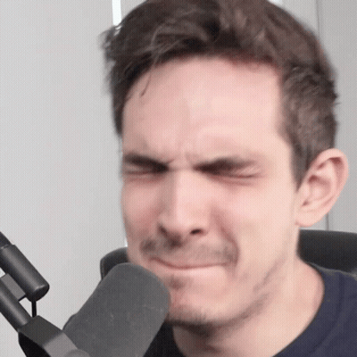 A Man With A Mustache Is Making A Funny Face In Front Of A Microphone GIF