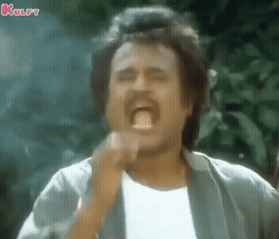 A Man With A Mustache Is Making A Funny Face With His Mouth Open And His Hand In His Mouth . GIF