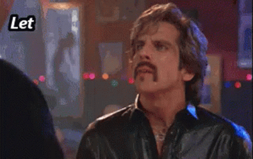 A Man With A Mustache Is Pointing At Someone With The Words Let Me Hit You With Some GIF