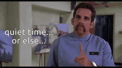 A Man With A Mustache Is Pointing At The Camera With The Words Quiet Time Or Else Behind Him .. GIF
