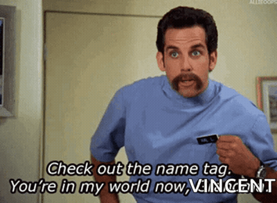 A Man With A Mustache Is Saying Check Out The Name Tag You 'Re In My World Now GIF