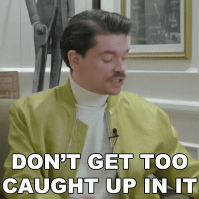 A Man With A Mustache Is Saying " Don 'T Get Too Caught Up In It " GIF