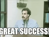 A Man With A Mustache Is Sitting At A Desk With The Words Great Success GIF