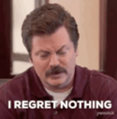 A Man With A Mustache Is Sitting At A Table With His Eyes Closed And Saying `` I Regret Nothing '' . GIF