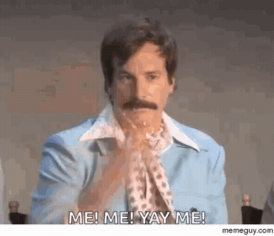A Man With A Mustache Is Sitting At A Table With His Hands Folded And Saying Me ! Me ! Yay Me ! GIF