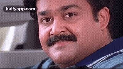 A Man With A Mustache Is Sitting In A Car . GIF