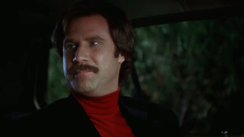 A Man With A Mustache Is Sitting In A Car With The Words " Agree To Disagree " Above Him GIF