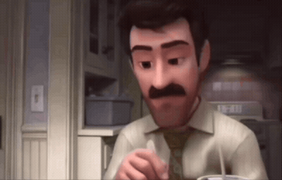 A Man With A Mustache Is Sitting In A Kitchen With A Cup Of Coffee In His Hand . GIF