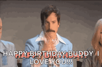 A Man With A Mustache Is Sitting In Front Of A Group Of People And Says Happy Birthday Buddy I Love You !!! GIF