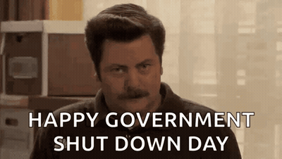 A Man With A Mustache Is Sitting In Front Of A Window And Says `` Happy Government Shut Down Day '' . GIF