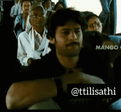 A Man With A Mustache Is Sitting On A Bus With Other People .. GIF
