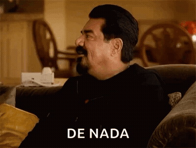 A Man With A Mustache Is Sitting On A Couch With A Bag Of Chips In His Hand . GIF