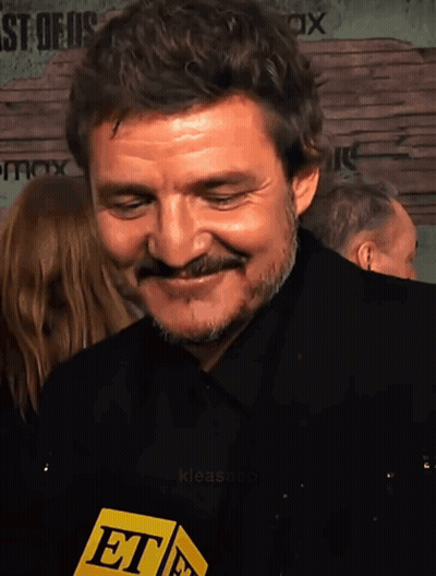 A Man With A Mustache Is Smiling And Holding A Microphone That Says Et On It GIF