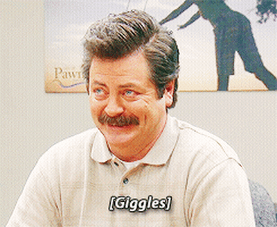 A Man With A Mustache Is Smiling With The Word Giggles On His Shirt GIF