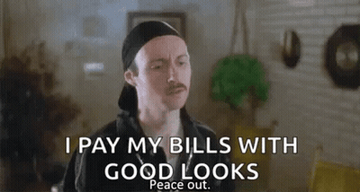 A Man With A Mustache Is Standing In A Living Room And Saying `` I Pay My Bills With Good Looks Peace Out '' GIF