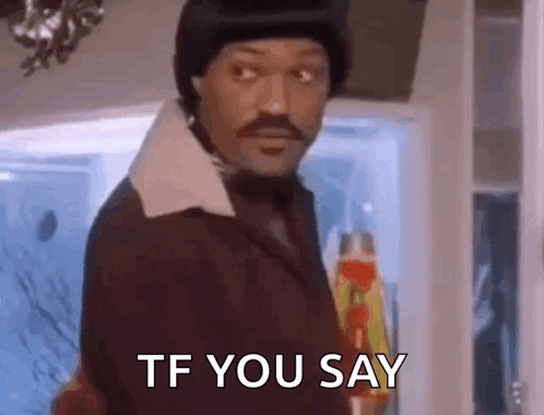 A Man With A Mustache Is Standing In Front Of A Door And Says `` Tf You Say '' . GIF