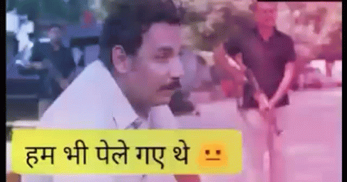 A Man With A Mustache Is Standing In Front Of A Sign That Says `` हम भी पेले गए थे '' . GIF