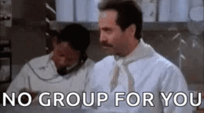 A Man With A Mustache Is Standing In Front Of A Sign That Says No Group For You . GIF