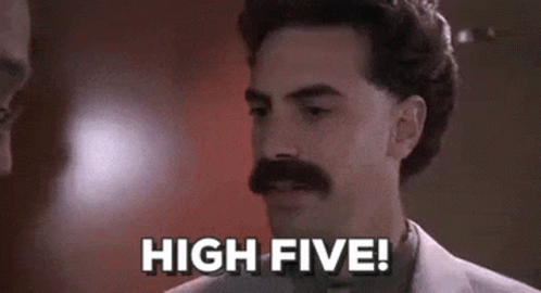 A Man With A Mustache Is Standing In Front Of A Wall And Says `` High Five '' . GIF