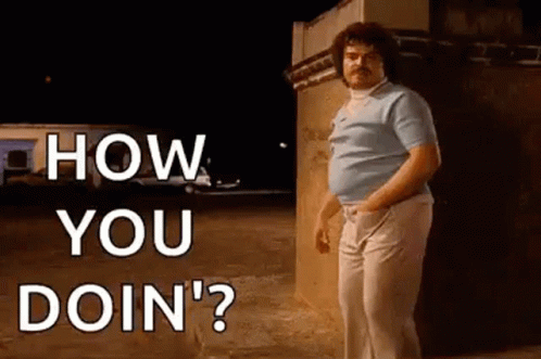 A Man With A Mustache Is Standing In Front Of A Wall . GIF