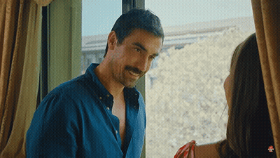 A Man With A Mustache Is Standing In Front Of A Window With A Woman GIF