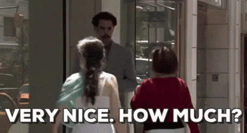 A Man With A Mustache Is Standing Next To Two Women And Says `` Very Nice How Much ? '' GIF
