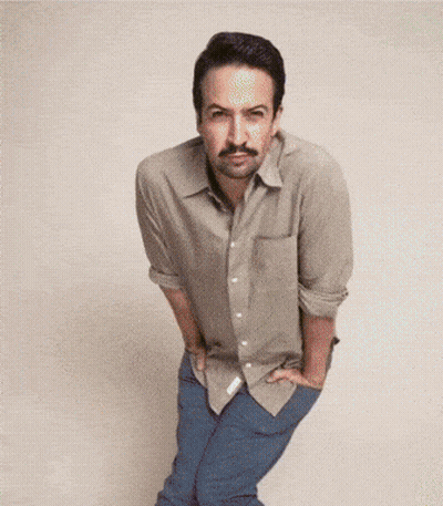 A Man With A Mustache Is Standing With His Hands On His Hips GIF