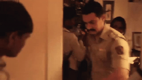 A Man With A Mustache Is Talking On A Phone GIF