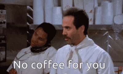 A Man With A Mustache Is Talking On A Phone While Another Man Says No Coffee For You GIF