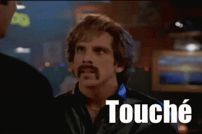 A Man With A Mustache Is Talking To Another Man And The Word Touche Is On The Screen Behind Him GIF