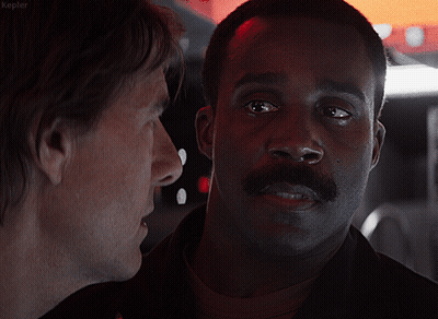 A Man With A Mustache Is Talking To Another Man With The Word Kepler On The Bottom Left GIF