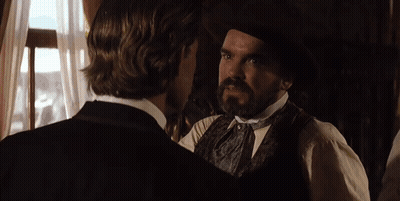 A Man With A Mustache Is Talking To Another Man With The Words Go Ahead Above Him GIF