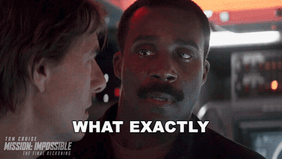A Man With A Mustache Is Talking To Another Man With The Words " What Exactly " Above Him GIF