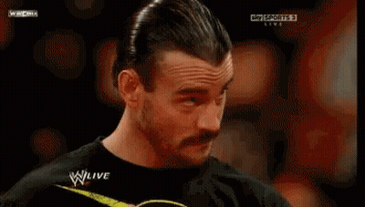 A Man With A Mustache Is Watching A Wrestling Match On Sky Sports Live GIF