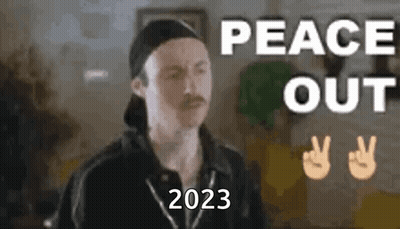 A Man With A Mustache Is Wearing A Baseball Cap And Making A Peace Sign . GIF