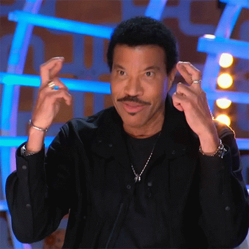 A Man With A Mustache Is Wearing A Black Shirt And Making A Funny Face GIF