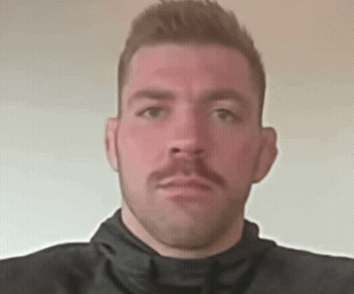 A Man With A Mustache Is Wearing A Black Turtleneck GIF