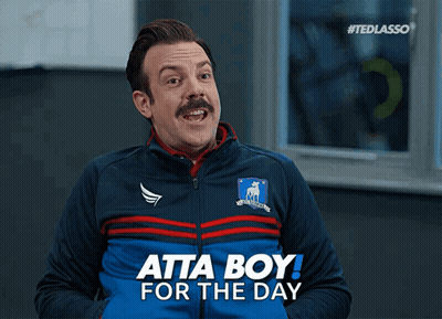 A Man With A Mustache Is Wearing A Blue Jacket That Says Atta Boy For The Day GIF