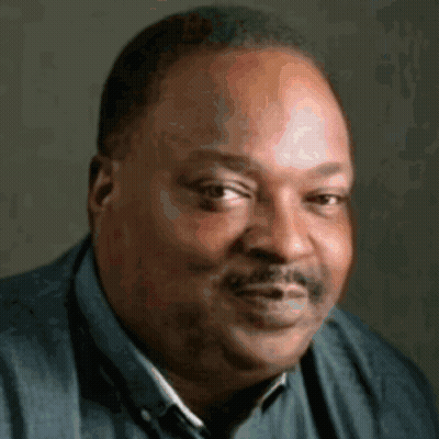 A Man With A Mustache Is Wearing A Blue Shirt And A Blue Vest GIF