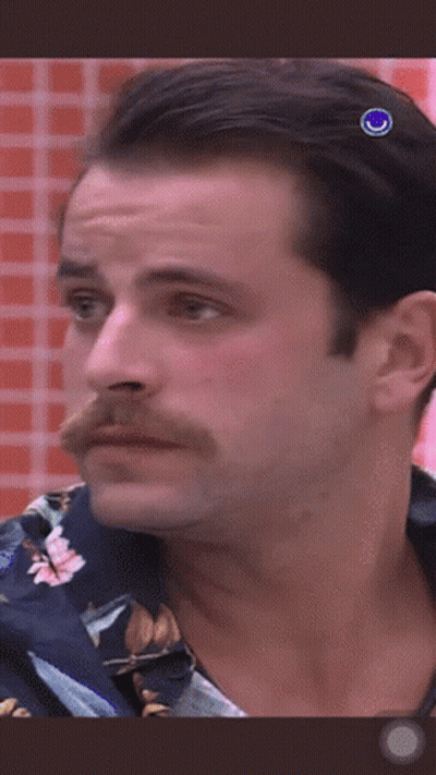 A Man With A Mustache Is Wearing A Blue Shirt GIF
