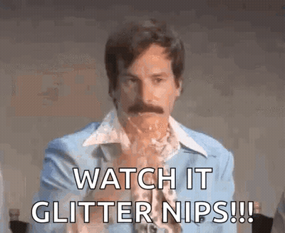 A Man With A Mustache Is Wearing A Blue Suit And Saying Watch It Glitter Nips . GIF