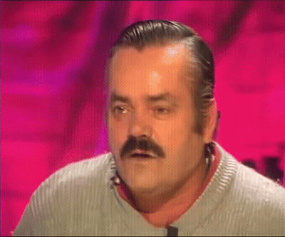 A Man With A Mustache Is Wearing A Grey Sweater And Making A Funny Face GIF