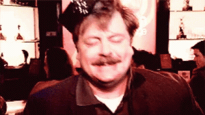 A Man With A Mustache Is Wearing A Party Hat And Making A Funny Face GIF