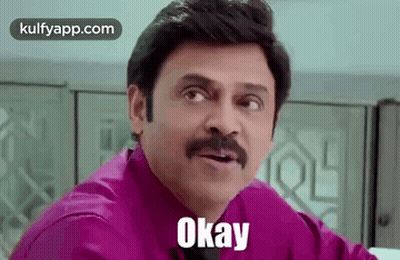 A Man With A Mustache Is Wearing A Purple Shirt And Tie And Says Okay . GIF