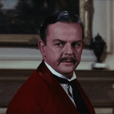 A Man With A Mustache Is Wearing A Red Jacket And Tie GIF