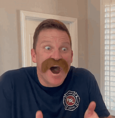 A Man With A Mustache Is Wearing A Shirt That Says Fbc GIF