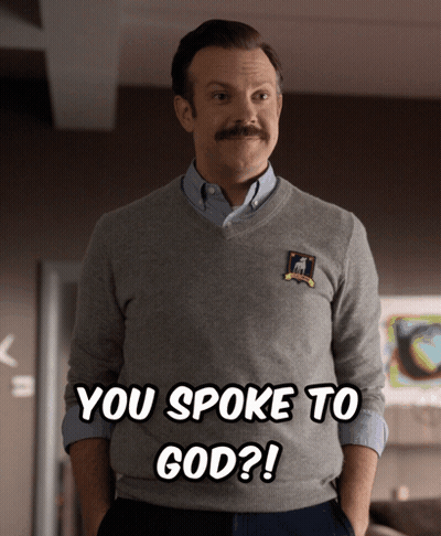 A Man With A Mustache Is Wearing A Sweater That Says You Spoke To God On It GIF
